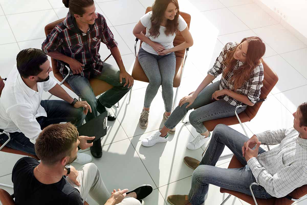 a group of people participate in group counseling for addiction recovery